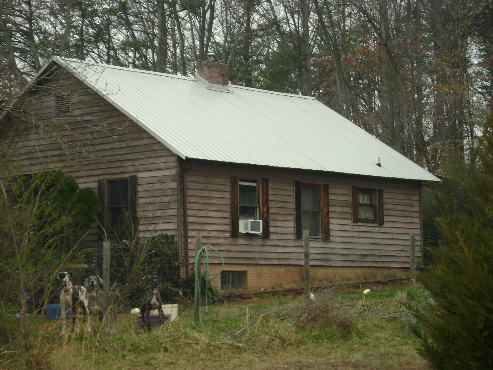 White metal roof on an old wood sided farmhouse, from a Metal Roof Installation job in Orinda